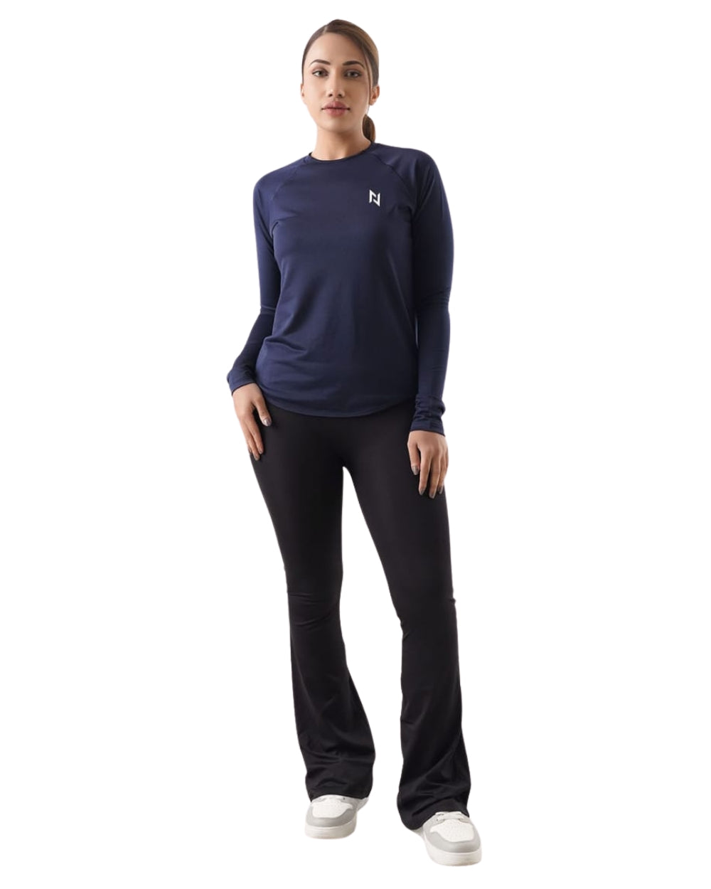 Woman wearing a navy long-sleeve top and black pants on a white background