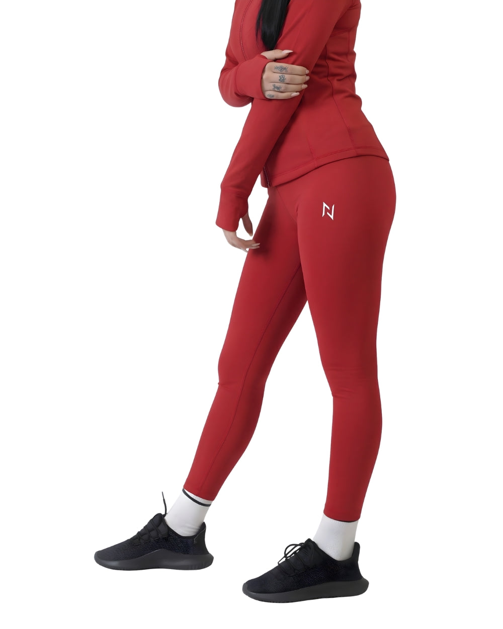 Person wearing a red tracksuit with a logo on a white background