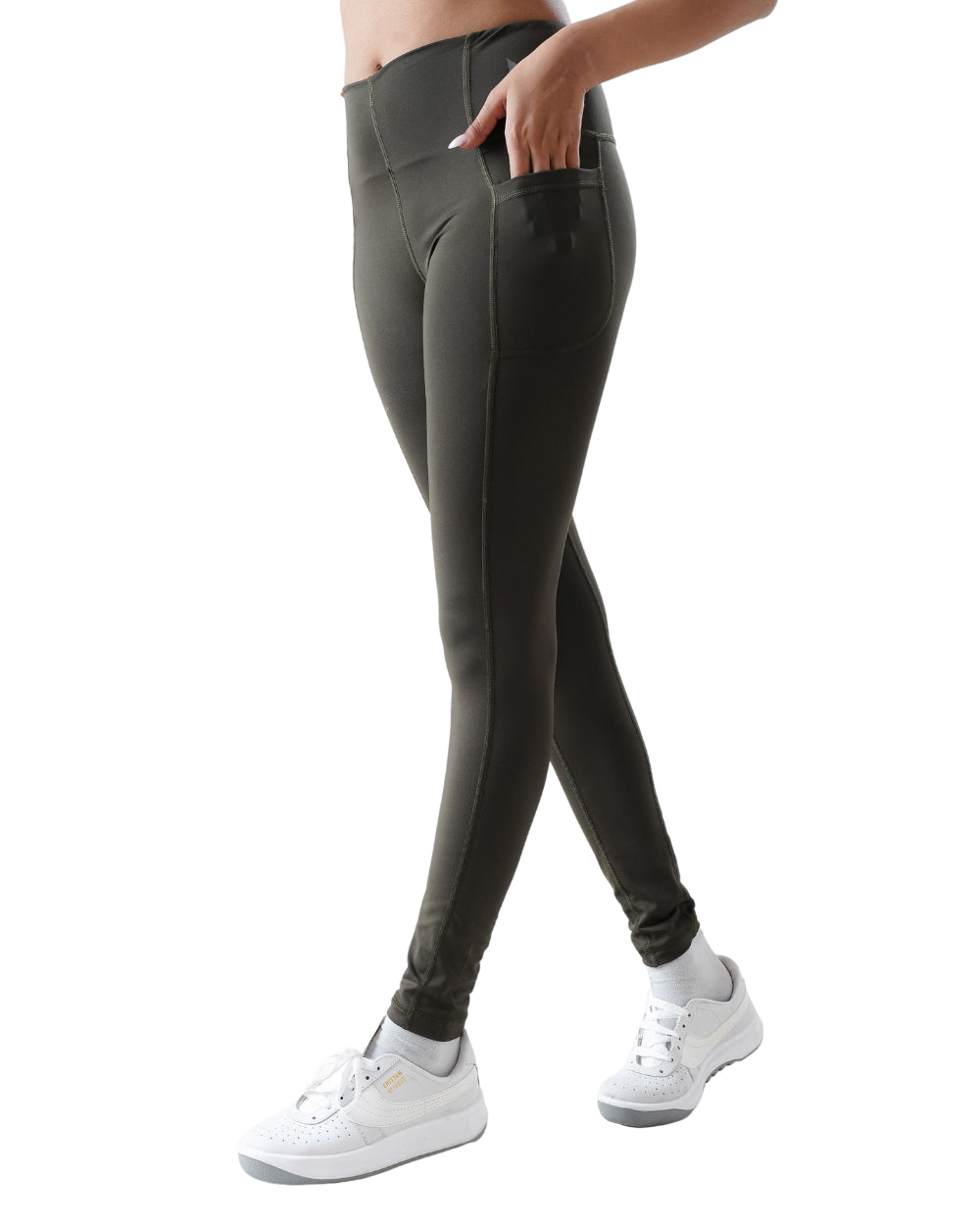 Person wearing dark gray leggings on a white background