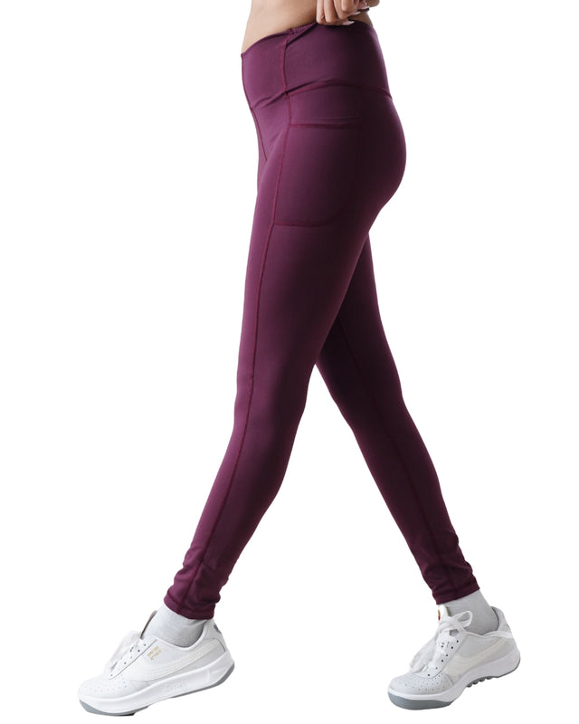 Purple leggings worn by a person on a white background
