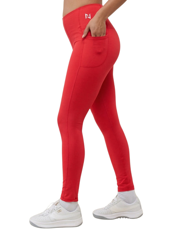 Red leggings with a brand logo worn by a person on a white background