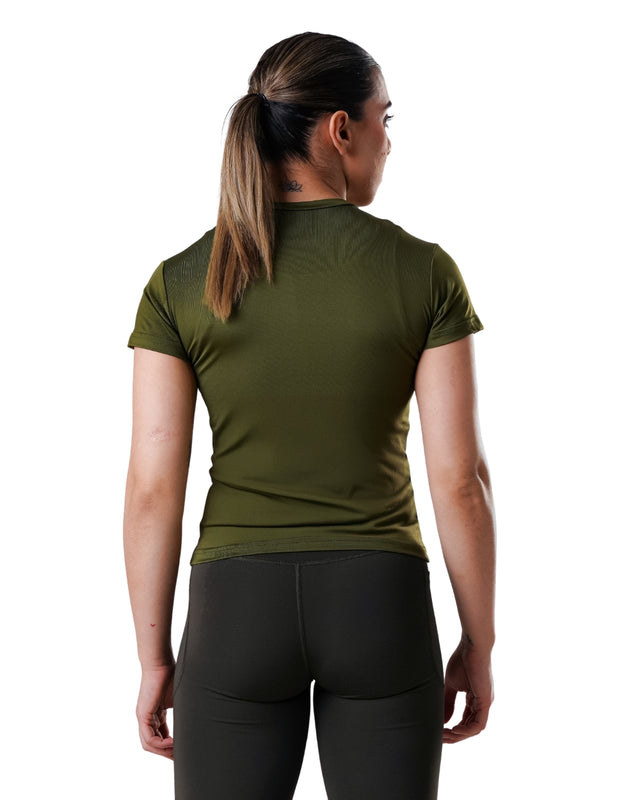 Woman wearing a green athletic shirt and black leggings on a white background