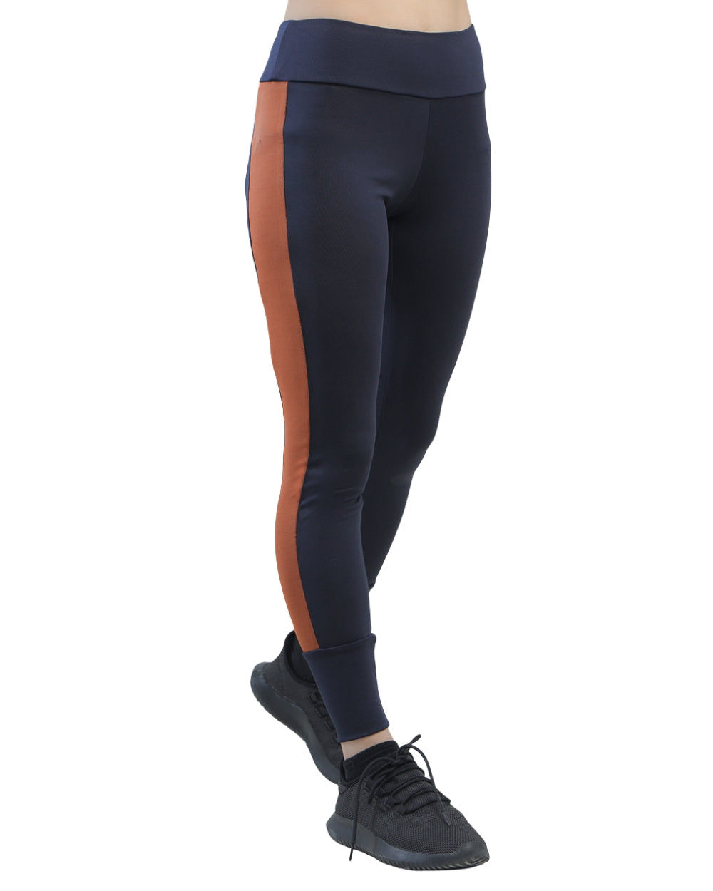 Navy leggings with orange side stripe worn by a person on a white background
