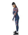 Woman wearing a blue athletic outfit with red floral patterns on a white background