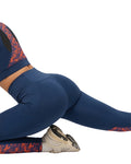 Navy blue leggings with red and orange pattern on a white background
