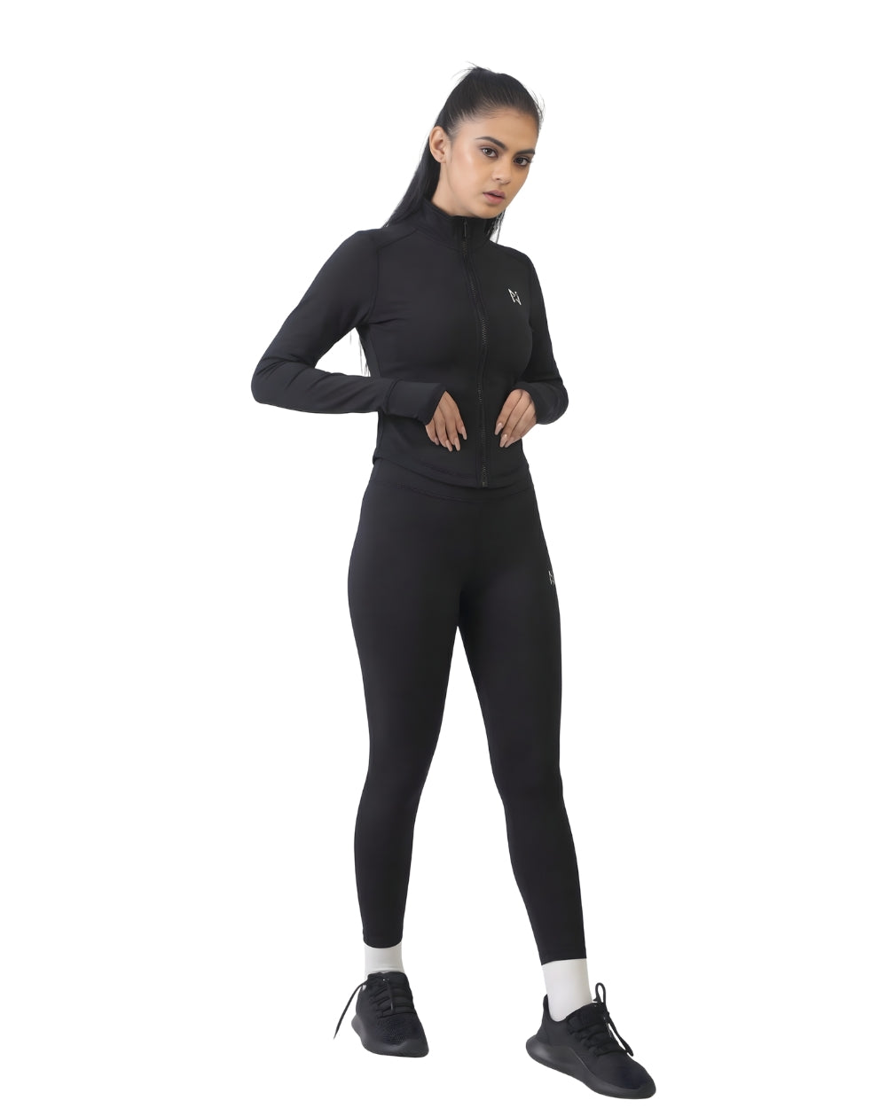 Person wearing a black long-sleeve top and leggings on a white background