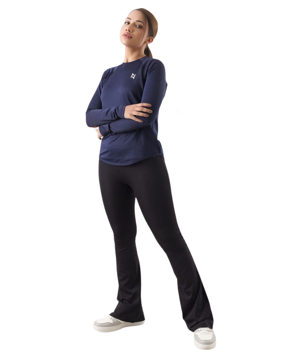 Woman wearing a navy long-sleeve top and black pants on a white background