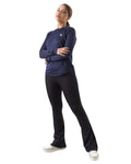 Woman wearing a navy long-sleeve top and black pants on a white background