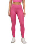 Person wearing bright pink leggings on a white background