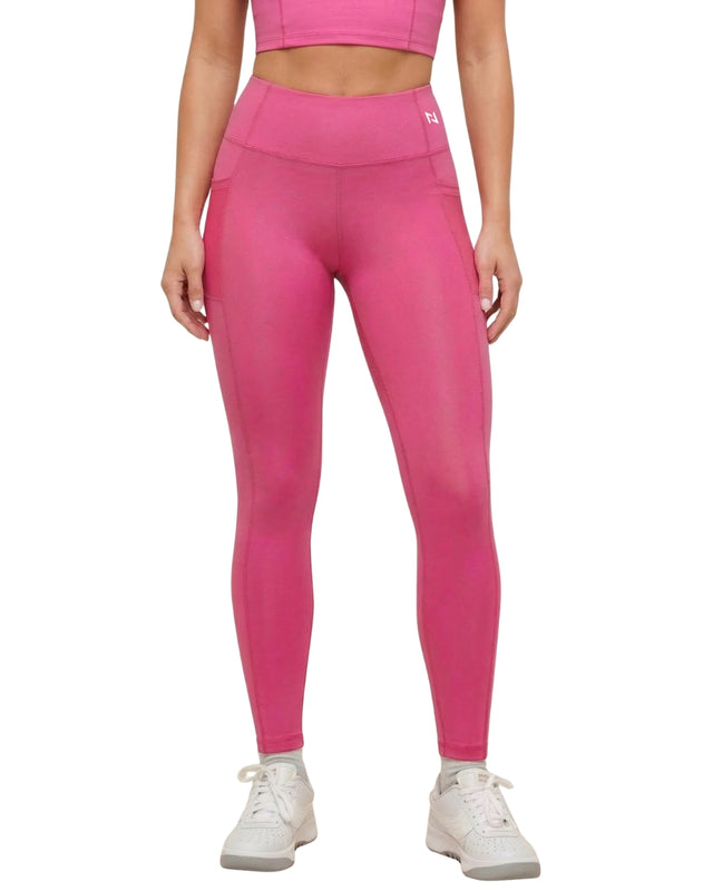 Person wearing bright pink leggings on a white background