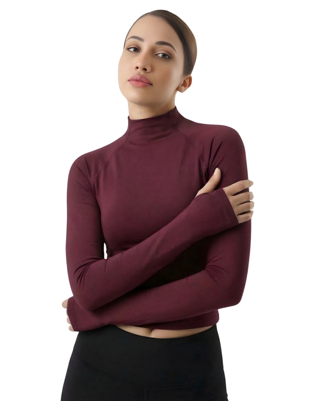 Woman wearing a burgundy turtleneck sweater on a white background