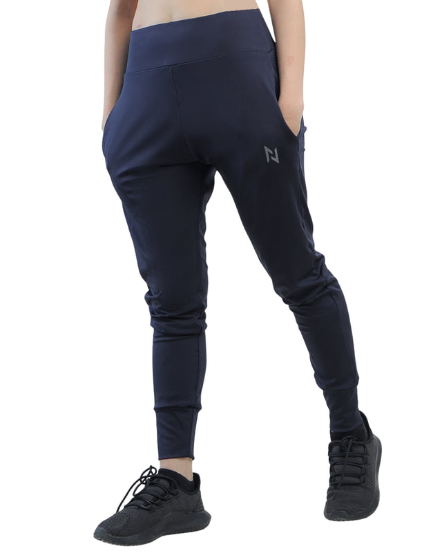 Navy blue jogger pants worn by a person on a white background