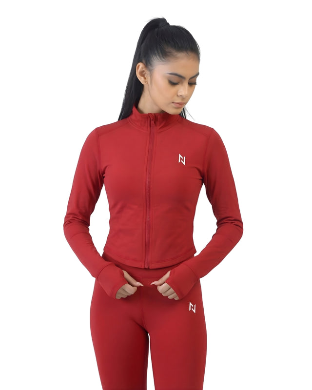 Woman wearing a red athletic outfit with a logo on a white background
