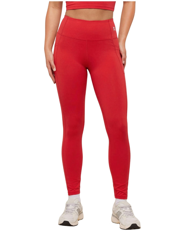 Red leggings worn by a person on a white background