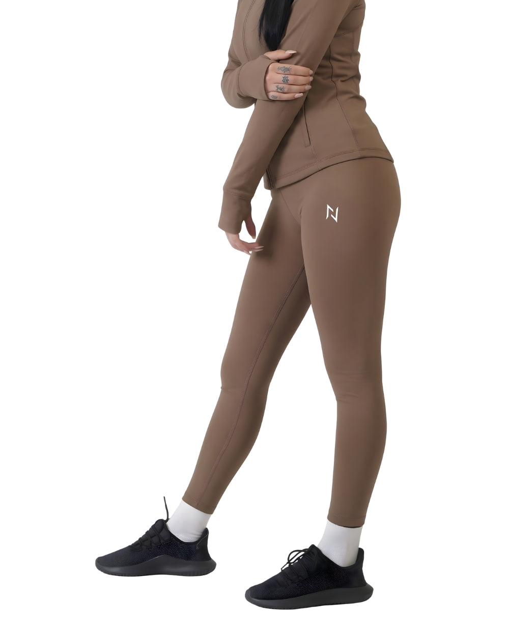 Person wearing a brown tracksuit with a logo on a white background