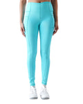 Turquoise leggings worn by a person on a white background