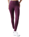 Purple leggings worn by a person on a white background
