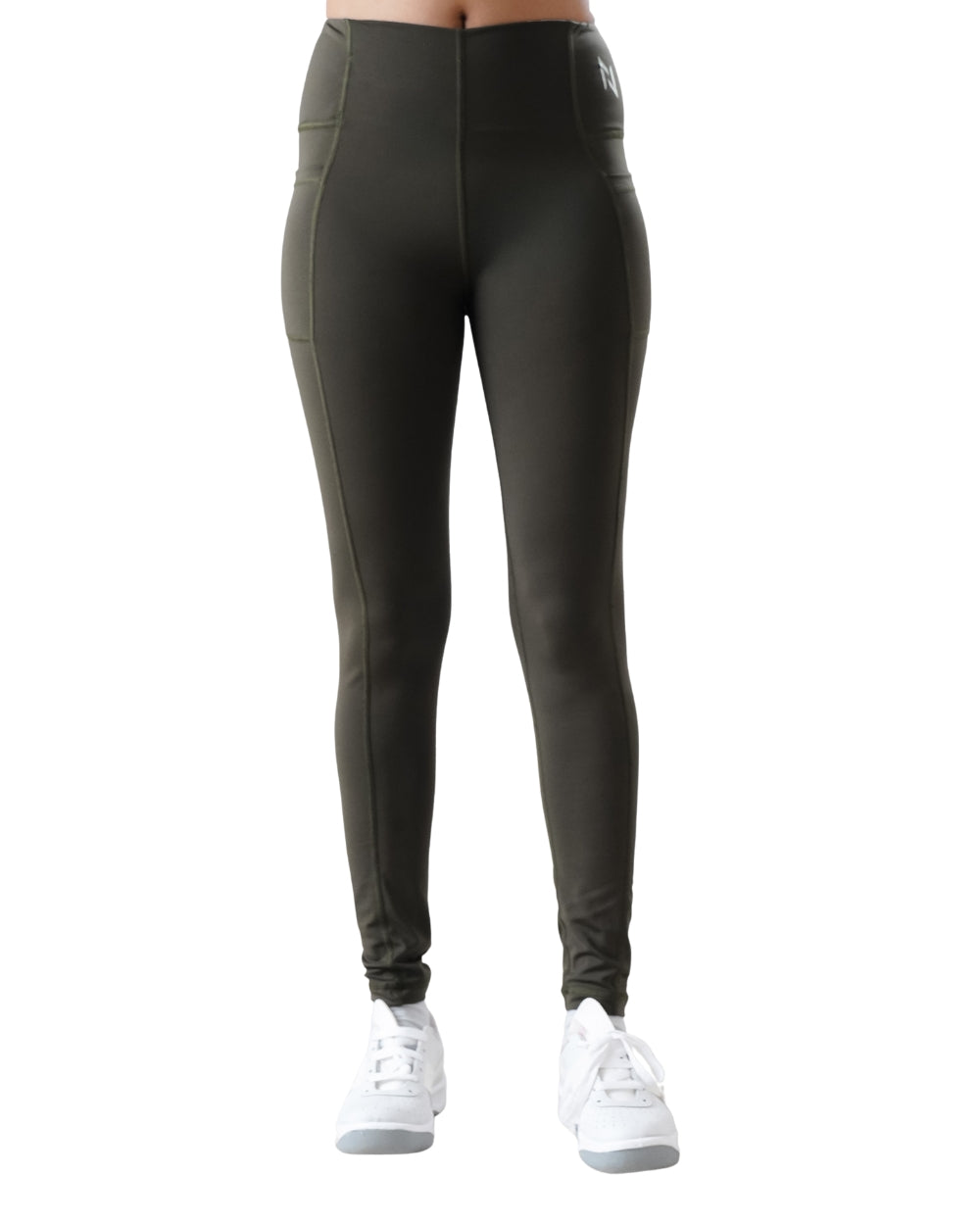 Dark green leggings worn by a person on a white background