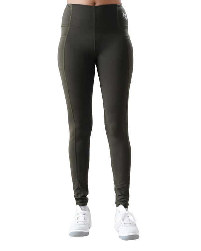 Dark green leggings worn by a person on a white background