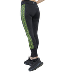 Black leggings with green snake pattern on a white background
