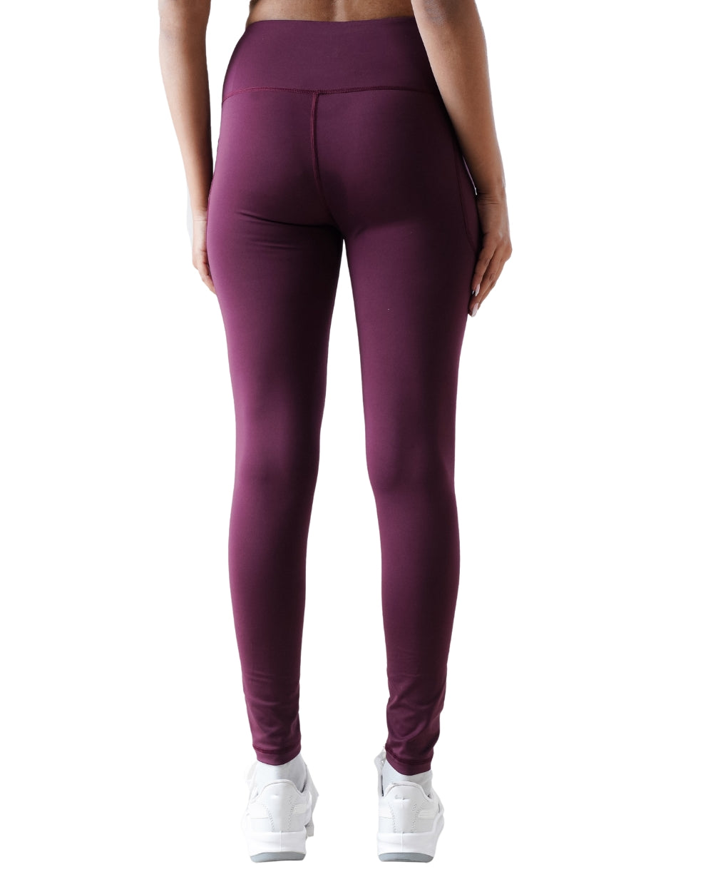 Purple leggings worn by a person on a white background