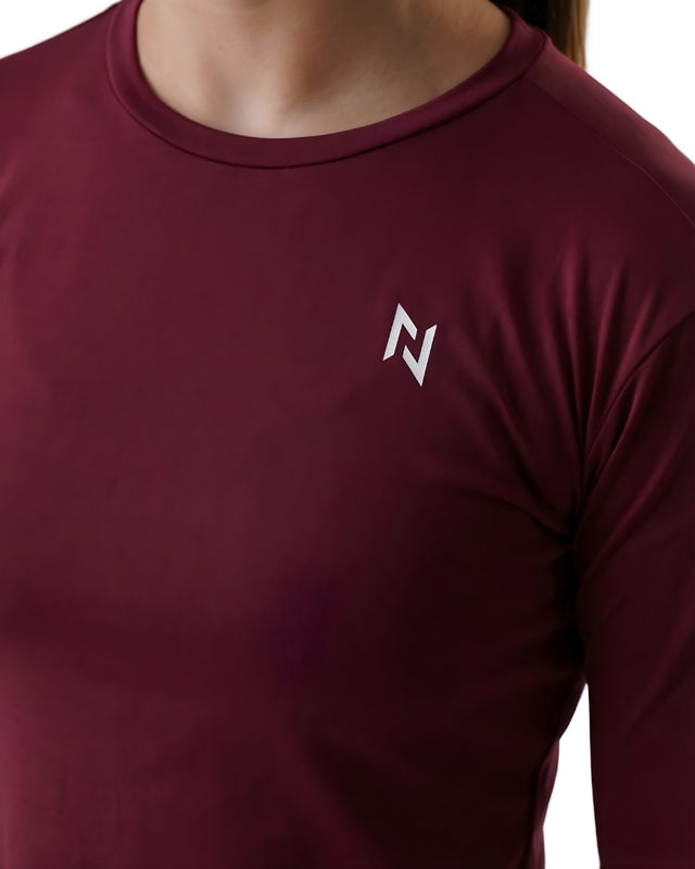Maroon long-sleeve shirt with a logo on the chest against a white background