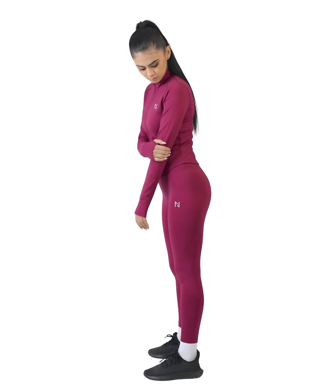 Woman wearing a pink athletic outfit with a logo on a white background