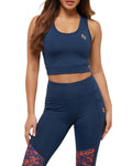 Woman wearing a navy sports bra and leggings with a logo on a white background