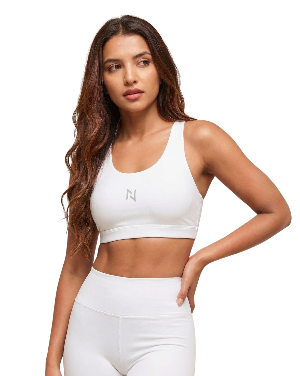 Woman wearing a white sports bra and leggings with a brand logo on a white background