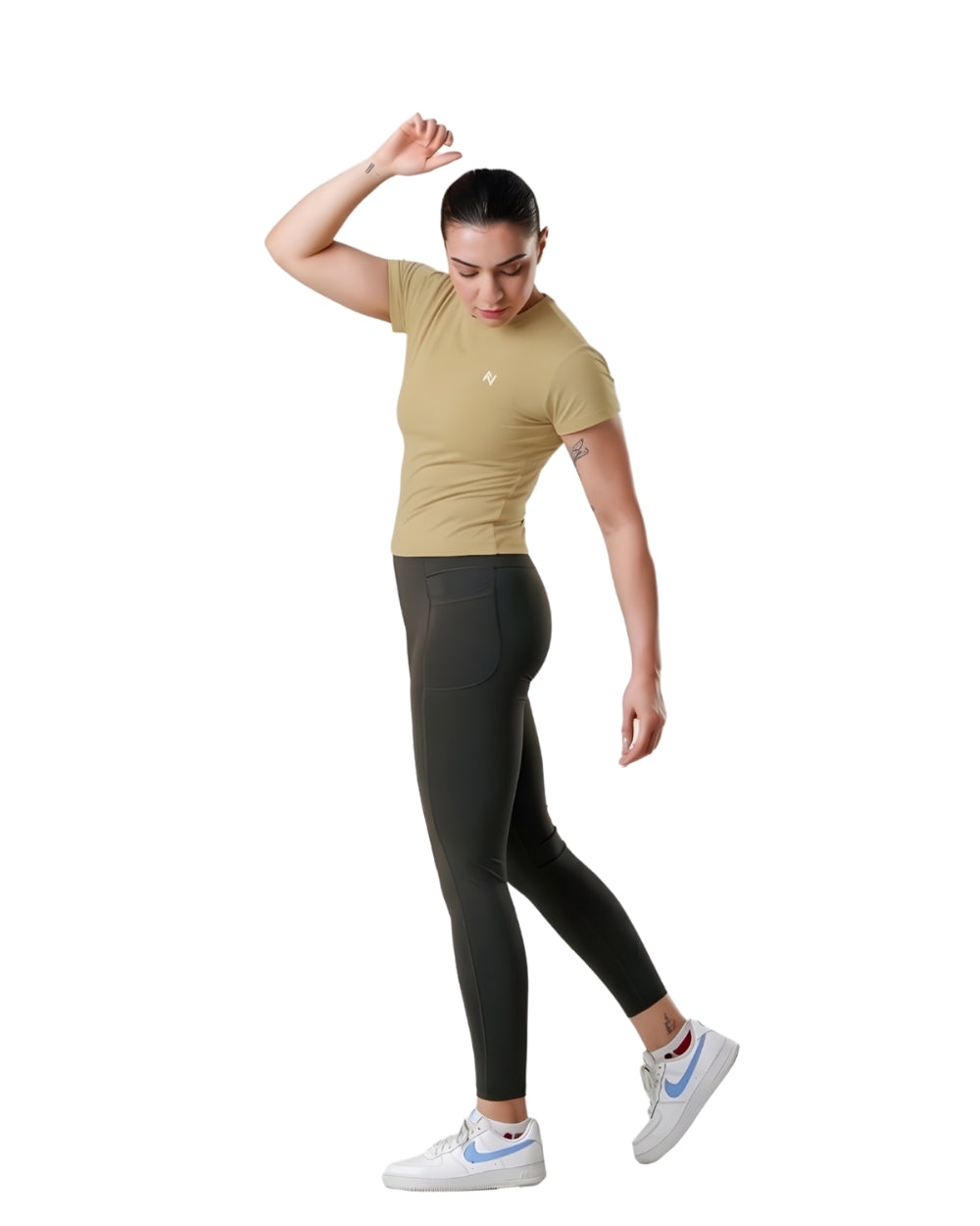 Woman wearing a beige t-shirt and black leggings on a white background
