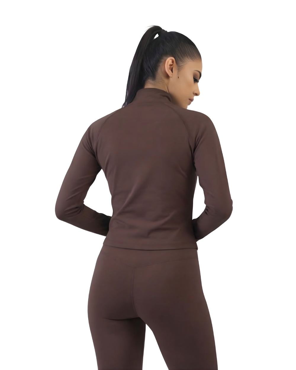 Woman wearing a brown long-sleeve top and leggings on a white background