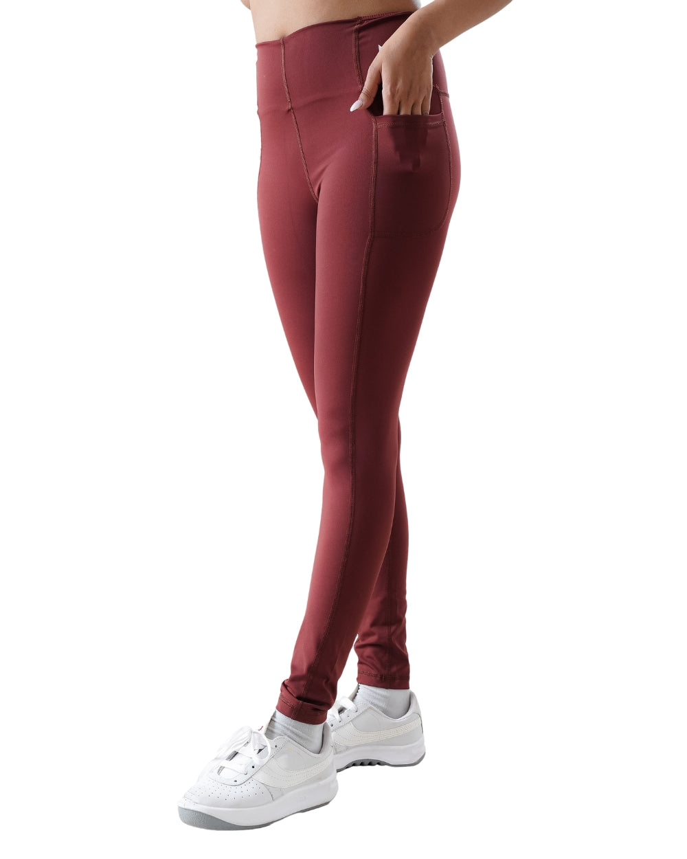 Maroon leggings worn by a person on a white background