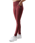 Maroon leggings worn by a person on a white background
