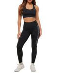 Person wearing a black sports bra and leggings set on a white background