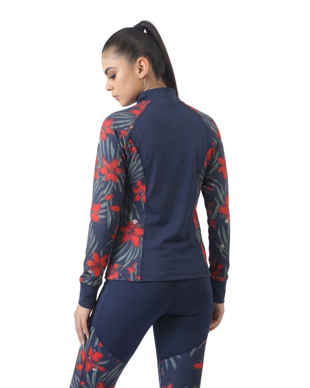 Woman wearing a navy athletic outfit with red and green floral patterns on a white background