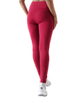 Red leggings worn by a person on a white background