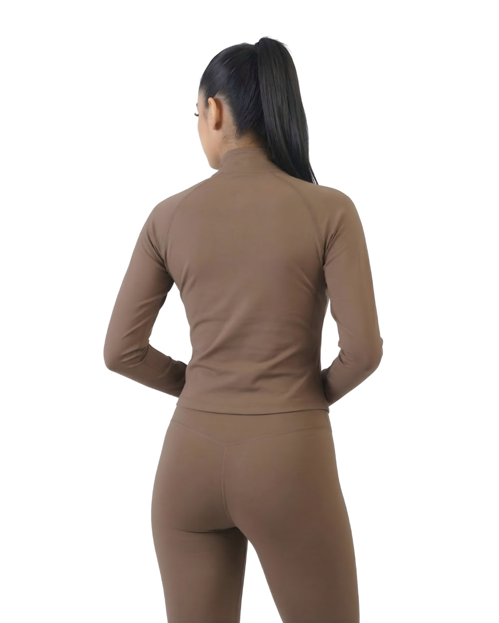Person wearing a brown long-sleeve top and leggings set on a white background