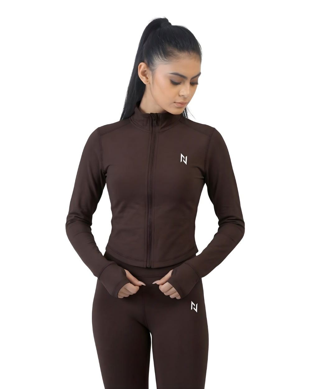 Woman wearing a brown athletic jacket and leggings with a logo on a white background