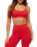Person wearing a red sports bra and leggings on a white background