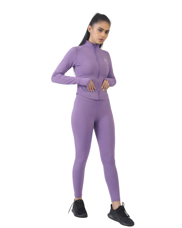 Woman wearing a purple athletic outfit on a white background