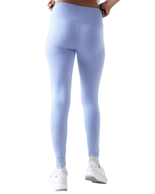 Light blue leggings worn by a person on a white background