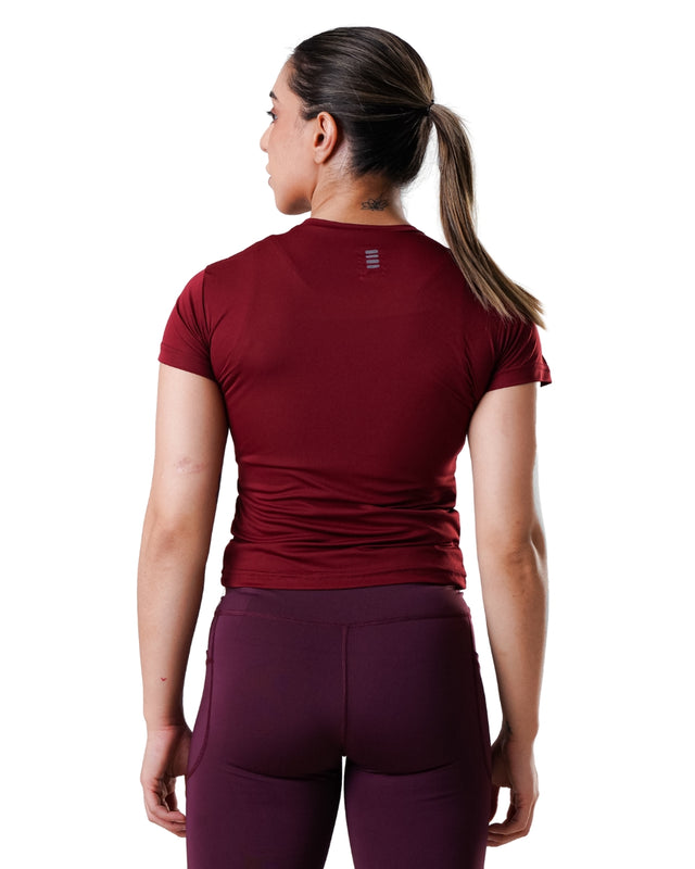 Person wearing a maroon athletic outfit on a white background