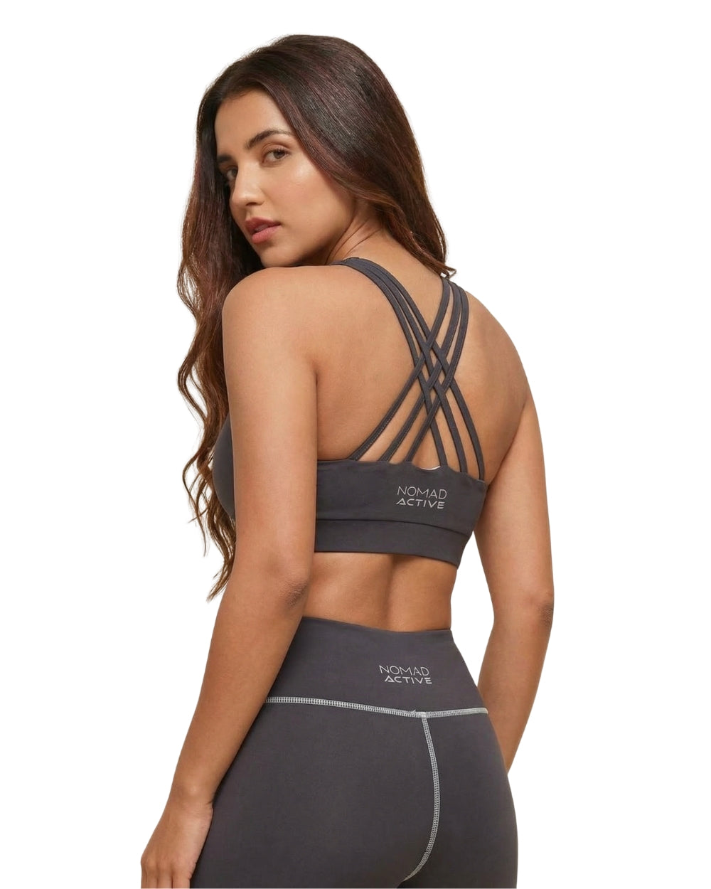Woman wearing a gray sports bra and leggings with 'Nomad Active' branding on a white background
