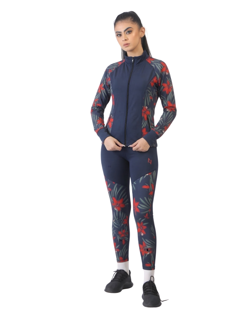 Person wearing a navy blue athletic outfit with red and green floral patterns on a white background