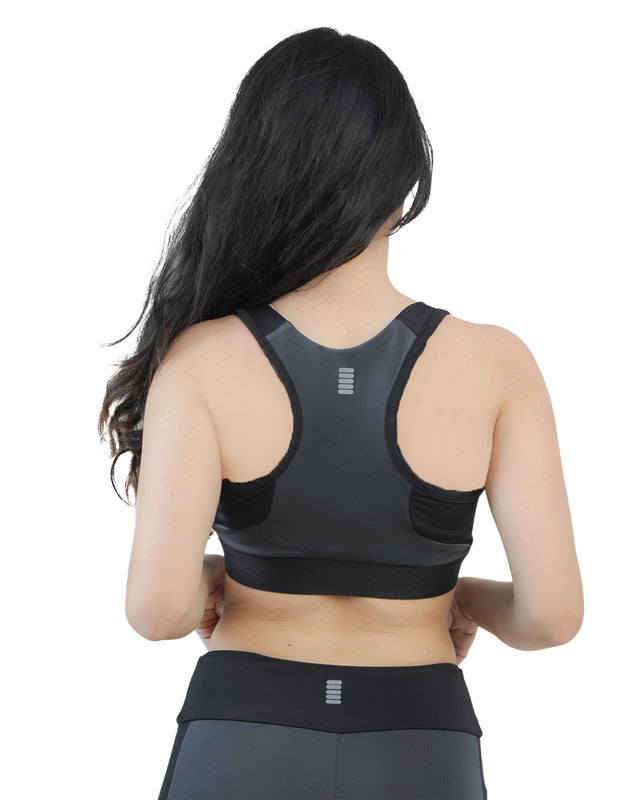 Black sports bra and leggings worn by a person on a white background