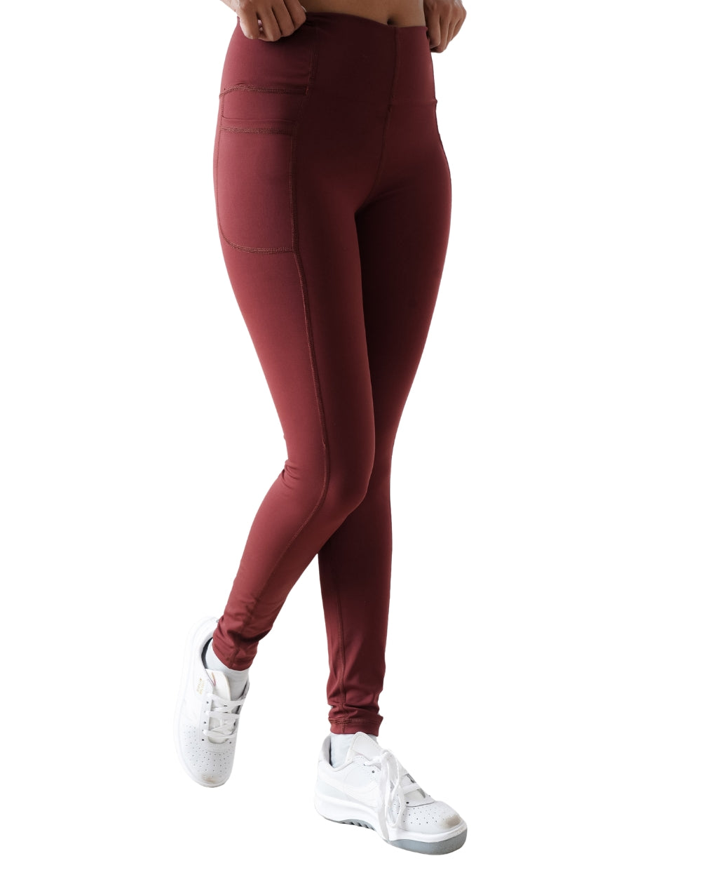 Maroon leggings worn by a person on a white background