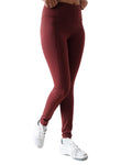 Maroon leggings worn by a person on a white background