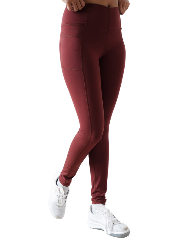 Maroon leggings worn by a person on a white background