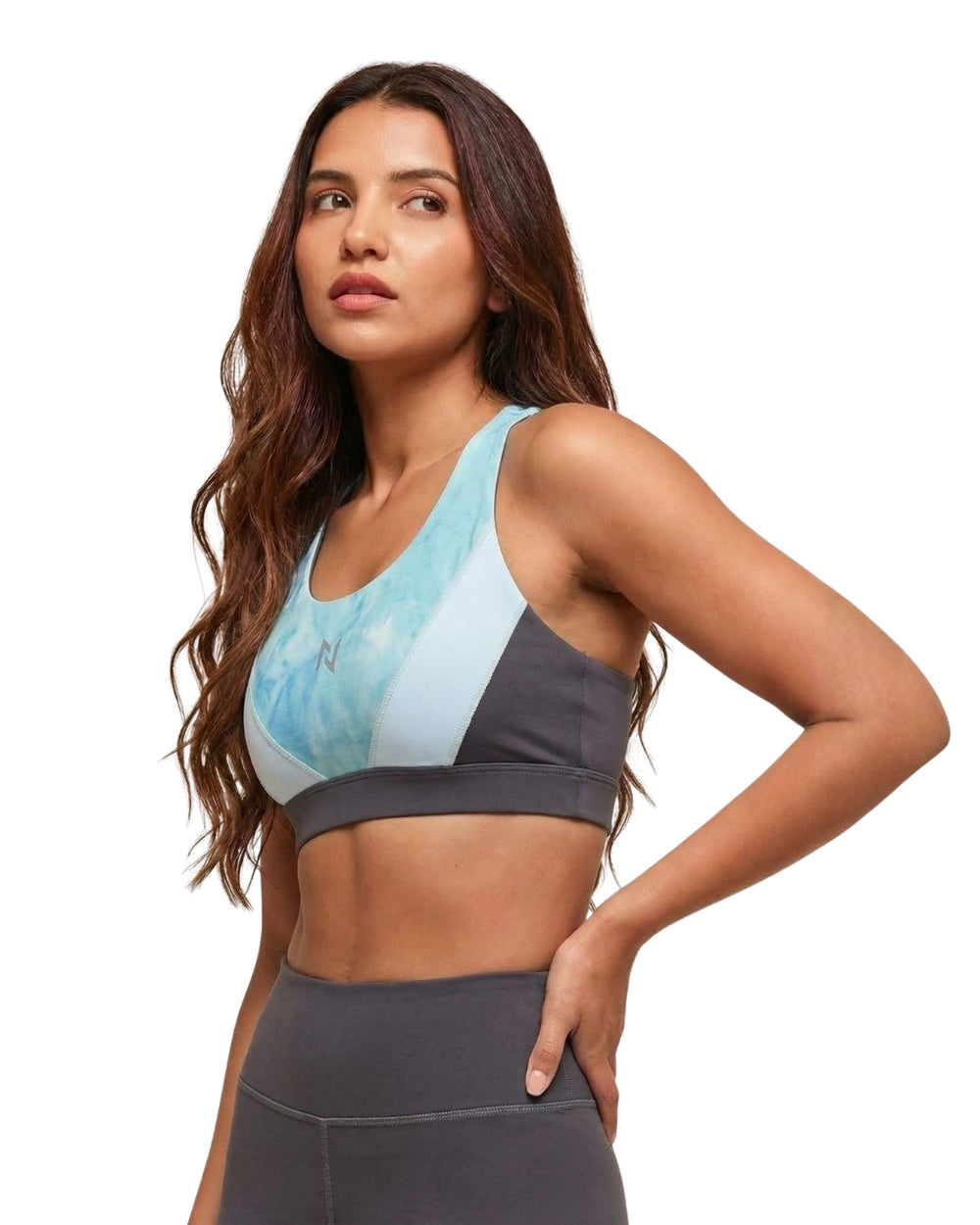 Woman wearing a sports bra and leggings on a white background