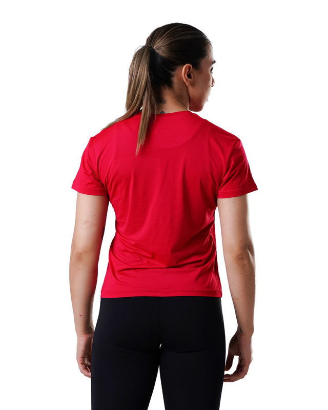 Person wearing a red athletic shirt and black leggings on a white background